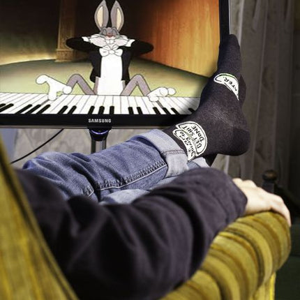 Get Shit Done Later Men's Socks- worn by model watching tv