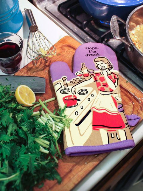 Oops, I'm Drunk Oven Mitt- on counter with cooking supplies