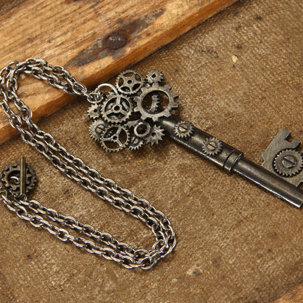 Antique Large Key Gear Necklace- on wooden display table 