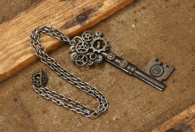 Antique Large Key Gear Necklace- on wooden display table 
