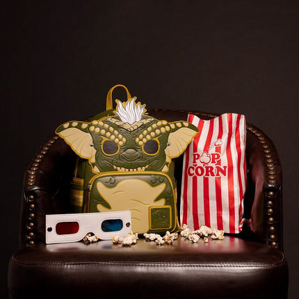 POP! Gremlins Stripe Cosplay Glow In The Dark Mini Backpack- pictured with popcorn at movie theatre