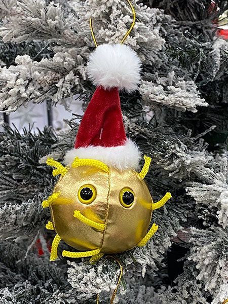 Golden covid ornament wearing a santa hat