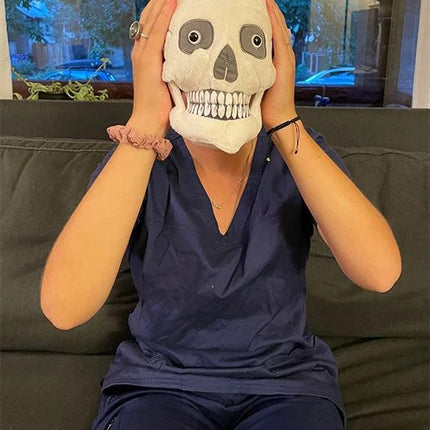 skull plushie held by model